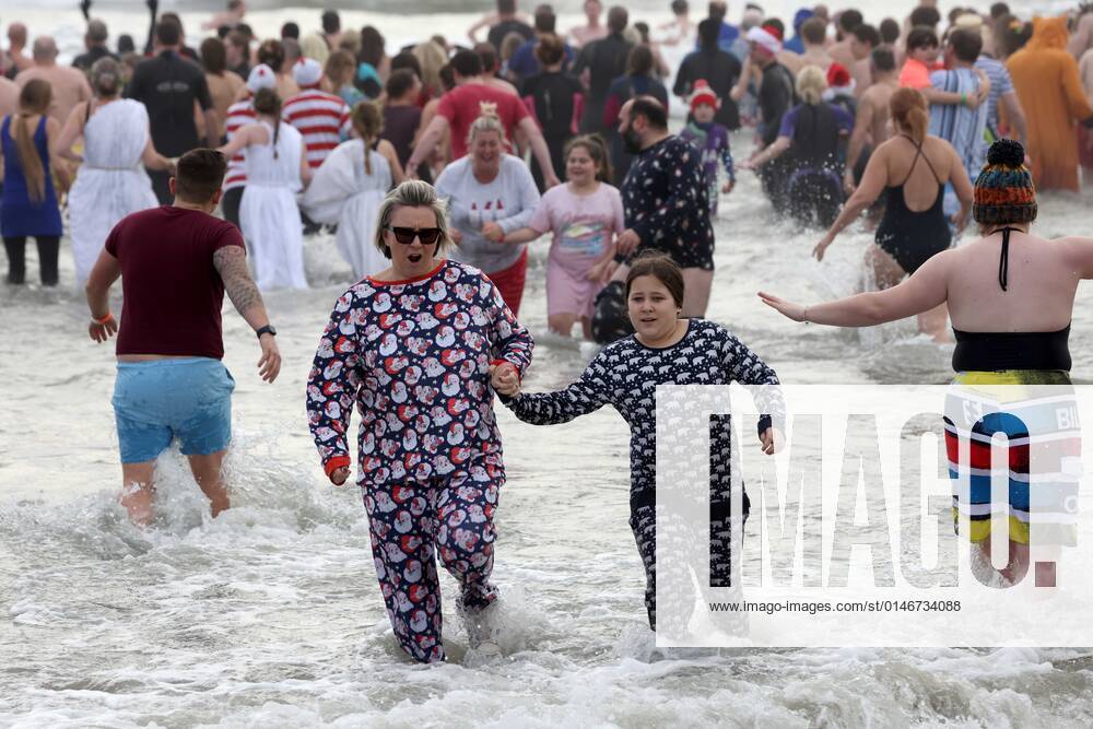 Over 350 New Year revellers, many in fancy dress, take part in the New Year Big Dip at East Wittering Beach in Chichester, West Sussex. More than double the previous record number of people took part, making the most of the warmest New YearÕs Day on record in the UK. JANUARY 1st 2022 MTXx2201