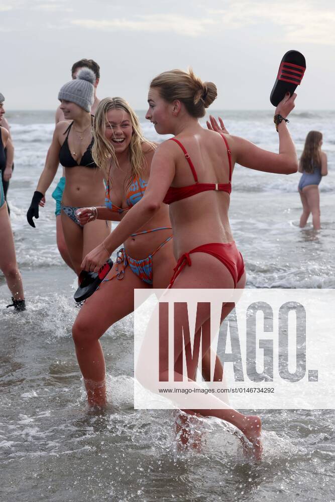 Over 350 New Year revellers, many in fancy dress, take part in the New Year Big Dip at East Wittering Beach in Chichester, West Sussex. More than double the previous record number of people took part, making the most of the warmest New YearÕs Day on record in the UK. JANUARY 1st 2022 MTXx2201