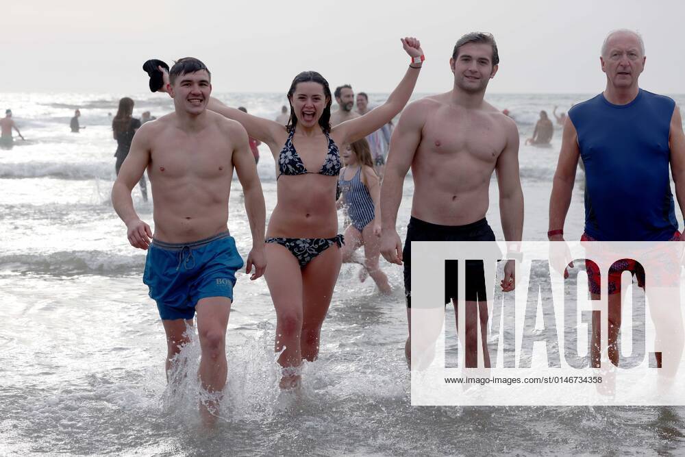 Over 350 New Year revellers, many in fancy dress, take part in the New Year Big Dip at East Wittering Beach in Chichester, West Sussex. More than double the previous record number of people took part, making the most of the warmest New YearÕs Day on record in the UK. JANUARY 1st 2022 MTXx2201