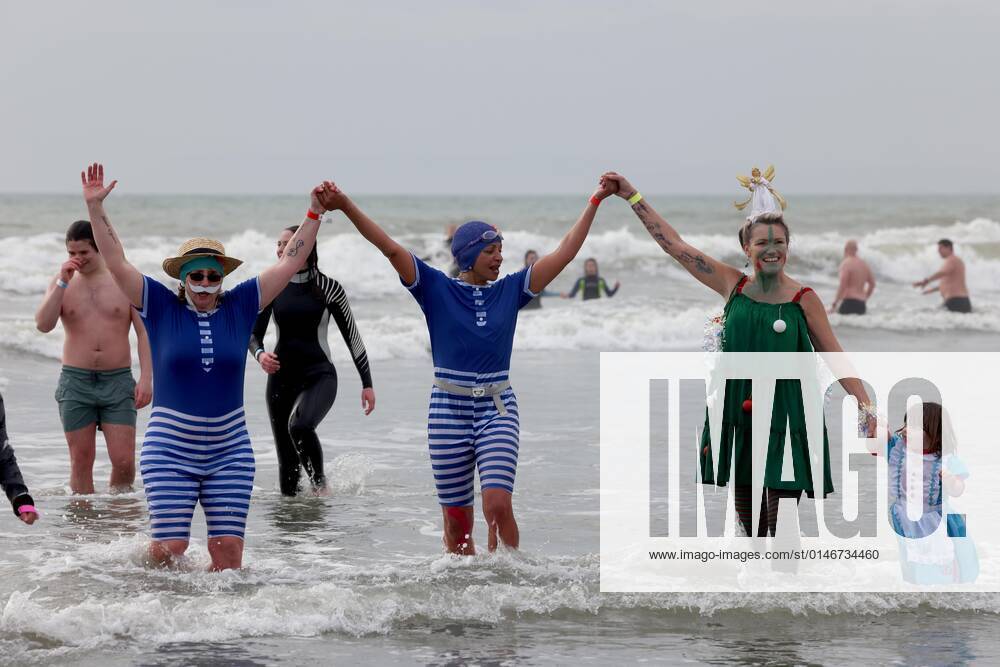 Over 350 New Year revellers, many in fancy dress, take part in the New Year Big Dip at East Wittering Beach in Chichester, West Sussex. More than double the previous record number of people took part, making the most of the warmest New YearÕs Day on record in the UK. JANUARY 1st 2022 MTXx2201