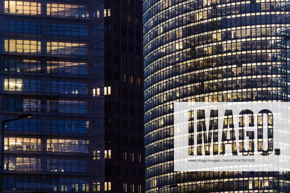 Illuminated windows in office buildings stand out at blue hour in Berlin, 10 01 2022 Berlin Germany