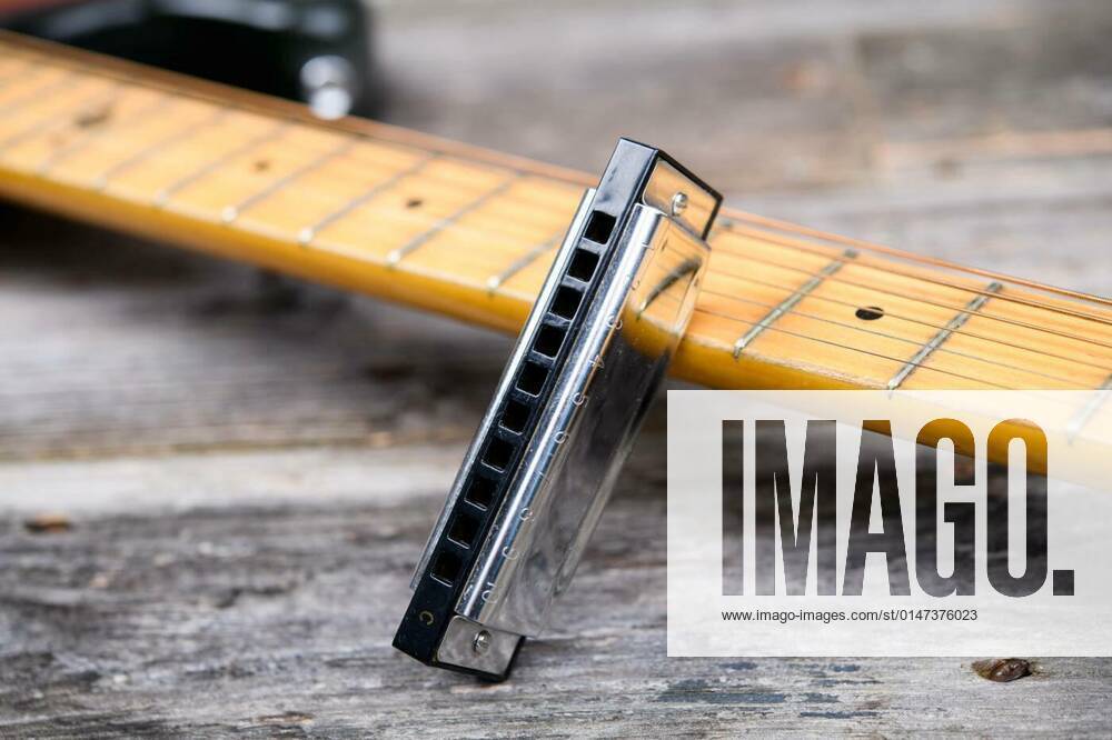 Guitar with blues harmonica on wooden ground, 26.09.2021,