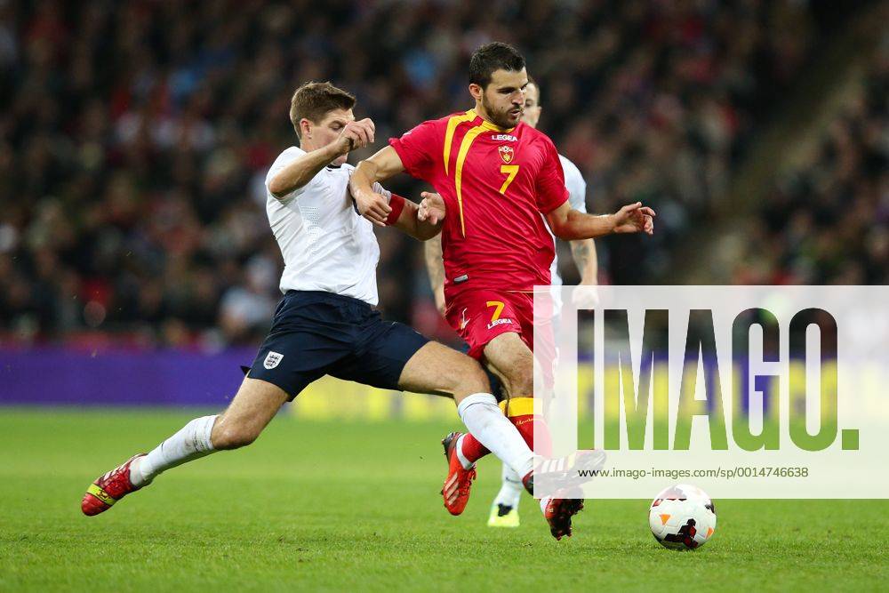 England v Montenegro - World Cup Qualifier - London - Wembley - England -11 10 2013 - England s Steven Gerrard challenges Montenegro s Simon Vukcevic Pic Charlie Forgham-Bailey Sportimage .