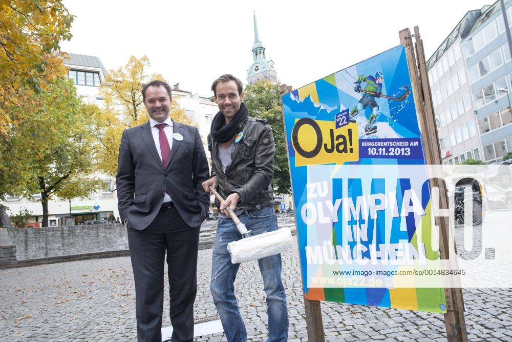 Plakataktion Buergerbegehren pro Olympia 2022, Rindermarkt, München. 22.12.2013 Thomas Muderlak, der Geschäftsführer der BMW Welt, Vorstandssprecher der Tourismus Initiative München, Mitbegründer des Team München 2022 und Sven Hannawald, Skispringer und Rennfahrer kleben Plakate Â