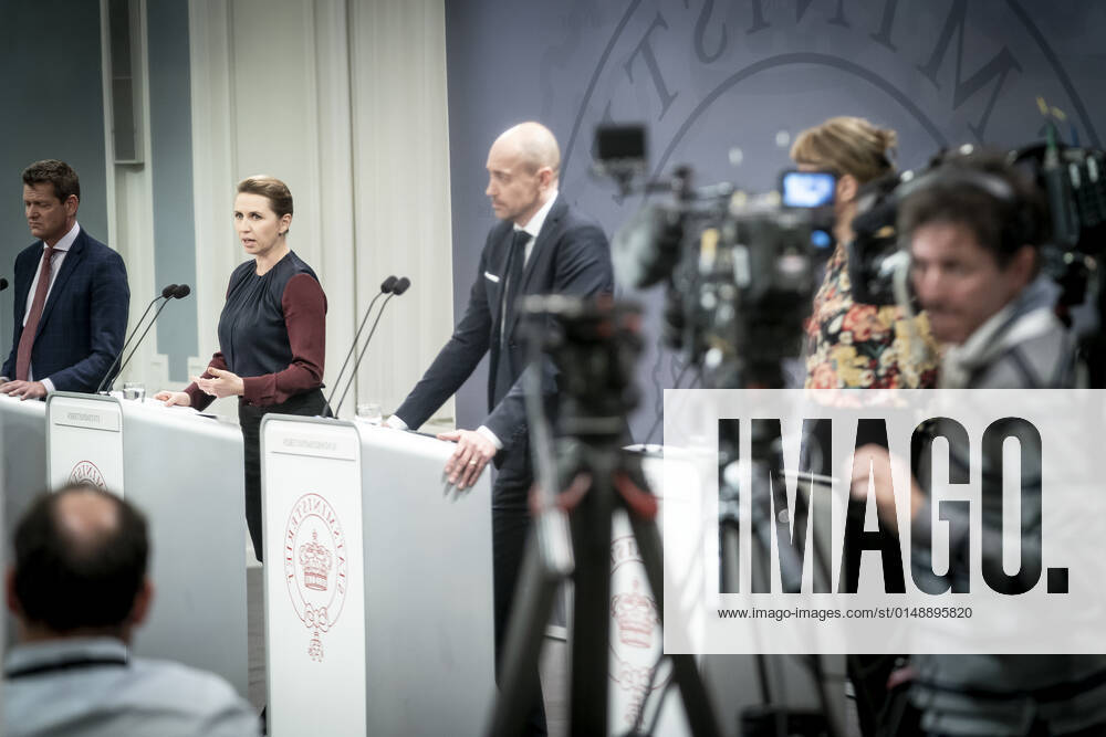 Prime Minister Mette Frederiksen S, Minister of Health Magnus Heunicke S and Director of the National Board of Health Soeren Brostroem photographed in a mirror during a press conference on the corona situation in the Mirror Room in the Prime Ministers Office, Wednesday 26 January 2022, Copenhagen Denmark