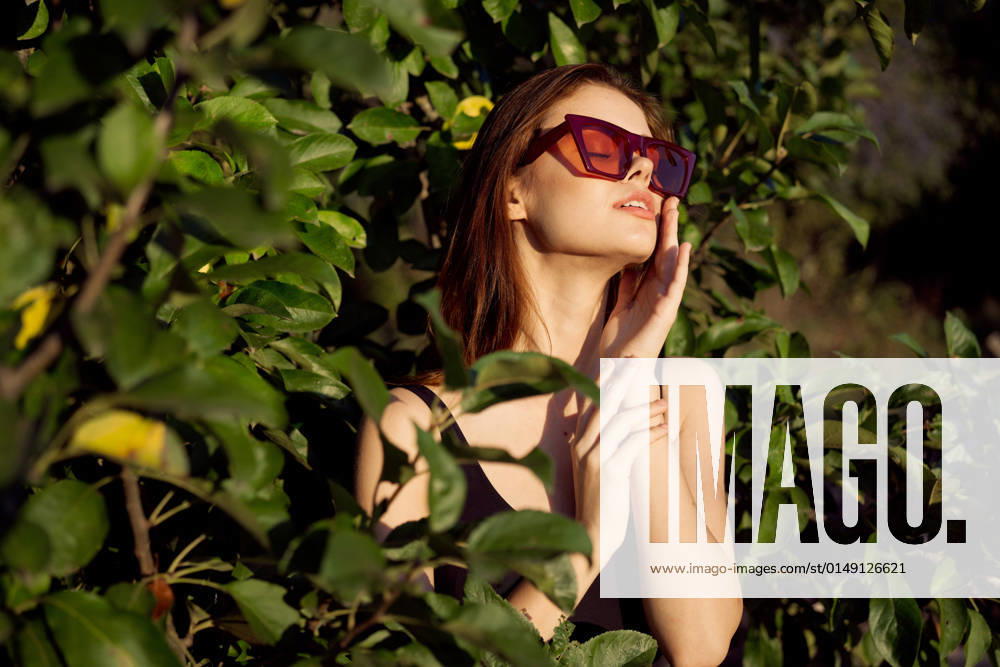 Pretty woman wearing sunglasses green leaves glamor posing summer pretty woman wearing sunglasses green leaves glamor posing summer. High quality photo