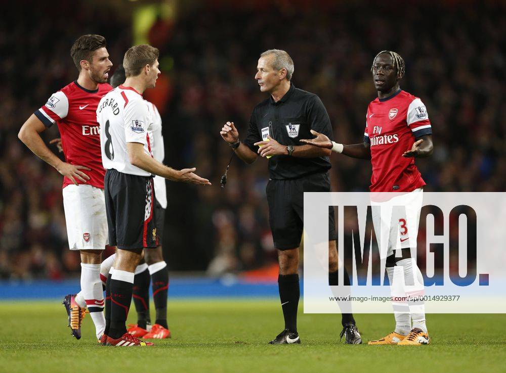 Arsenal s Bacary Sagna pleads his innocence as Liverpool s Steven Gerrard questions referee Martin Atkinson s decision not to play the advantage Arsenal v Liverpool - Barclays Premier League - Emirates Stadium - London - England -02 11 2013 - Pic David Klein Sportimage .