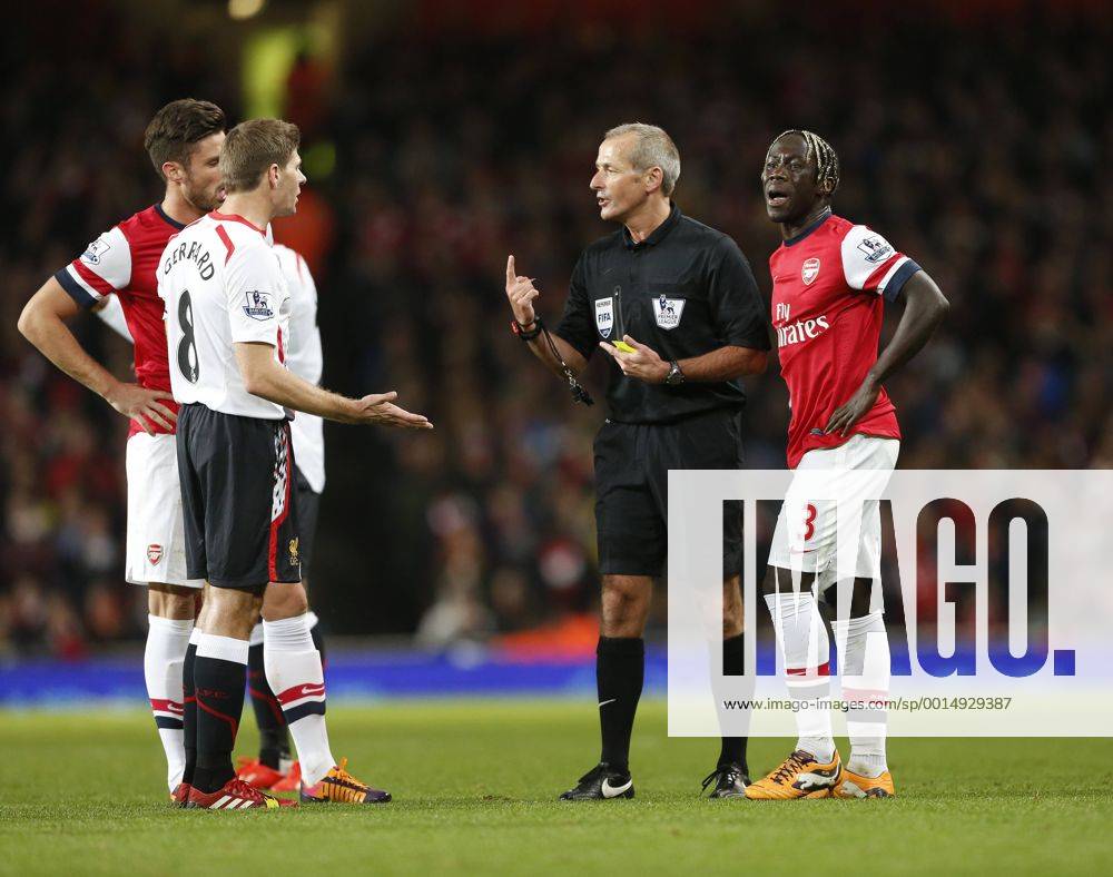 Arsenal s Bacary Sagna pleads his innocence as Liverpool s Steven Gerrard questions referee Martin Atkinson s decision not to play the advantage Arsenal v Liverpool - Barclays Premier League - Emirates Stadium - London - England -02 11 2013 - Pic David Klein Sportimage .