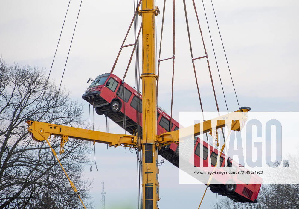 A crane slowly removes the 60 foot long articulated Port Authority bus from the site of the Fern Hollow Bridge collapse on Monday, January 31, 2022 in Frick Park in Pittsburgh. The bridge collapsed on Friday morning with injuries, but no lost of life. PIT2022013103 ARCHIExCARPENTER