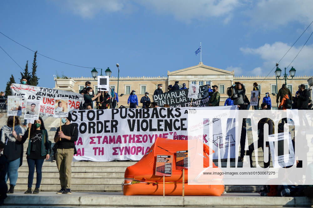 Greece: Protest against migrant pushbacks and border violence in Athens Protesters hold signs and banners reading Stop pushbacks and border violence as they stand next to a life raft with the Greek Parliament in the background in Syntagma square. Hundreds of protesters hit the streets of the Greek capital on Sunday, to protest what they say are Greece’s pushbacks of migrants and refugees at the border with Turkey. Athens Greece