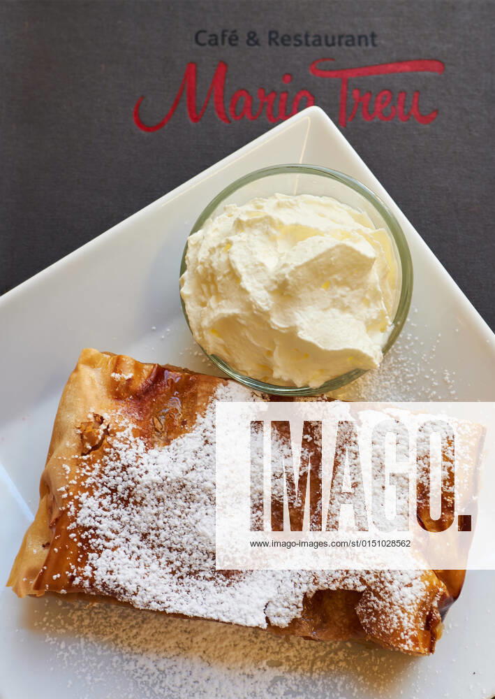WIen, Austria February 10, 2022 Cafe Maria Treu view of an apple strudel with whipped cream and a menu WIen Vienna Austria