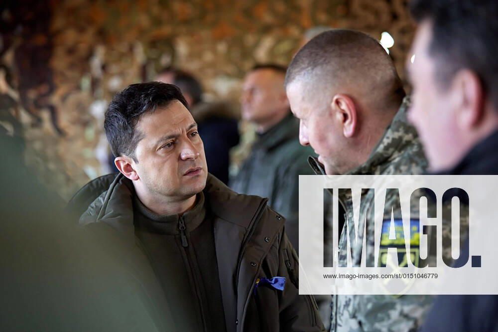 Ukrainian President Volodymyr Zelensky (L) listens to explanations during a military drill outside the city of Rivne, northern Ukraine on Wednesday on February 16, 2022. KYV2022021604A UkrainianxDefencexministryxpress
