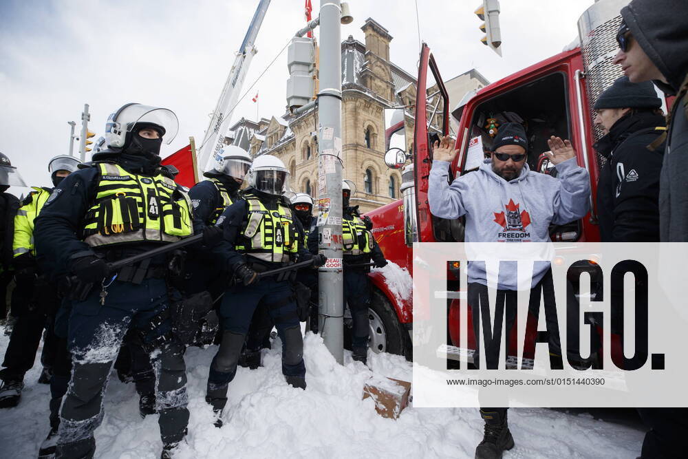 A man steps out of truck as police move in to clear downtown Ottawa near Parliament hill of protesters after weeks of demonstrations on Saturday, Feb. 19, 2022. Police arrested scores of demonstrators and towed away vehicles Friday in Canada s besieged capital, and a stream of trucks started leaving under the pressure, raising authorities hopes for an end to the three-week protest against the country s COVID-19 restrictions. Ottawa Canada - ZUMAc35_ 20220219_zaf_c35_056