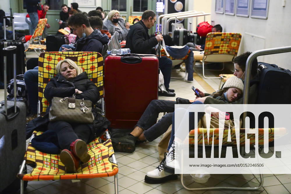 People Arrive In Poland After Fleeing Ukraine Passengers rest on camp beds in a temporary shelter inside a building of the railway station after arriving on a train from Kiev in Ukraine to Przemysl, Poland on February 25, 2022. Russian invasion on Ukraine can cause a mass exodus of refugees to Poland. Przemysl Poland