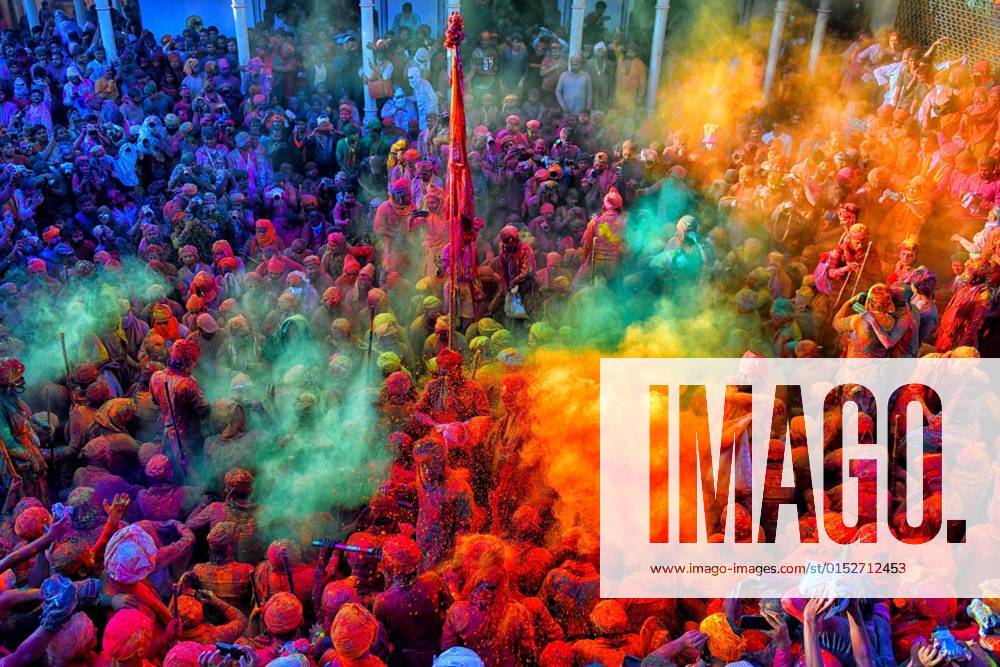 Hindu devotees play with colorful powders (Gulal) at the Radharani Temple of Nandgaon during the festival. Holi Festival of India is one of the biggest colorful celebrations in India as many Tourists and devotees gather to observe this colorful event. Marking the beginning of spring, the festival celebrates the divine love of Radha and Krishna and represents the victory of good over evil. Mathura India - ZUMAs197 20220312_zaa_s197_667