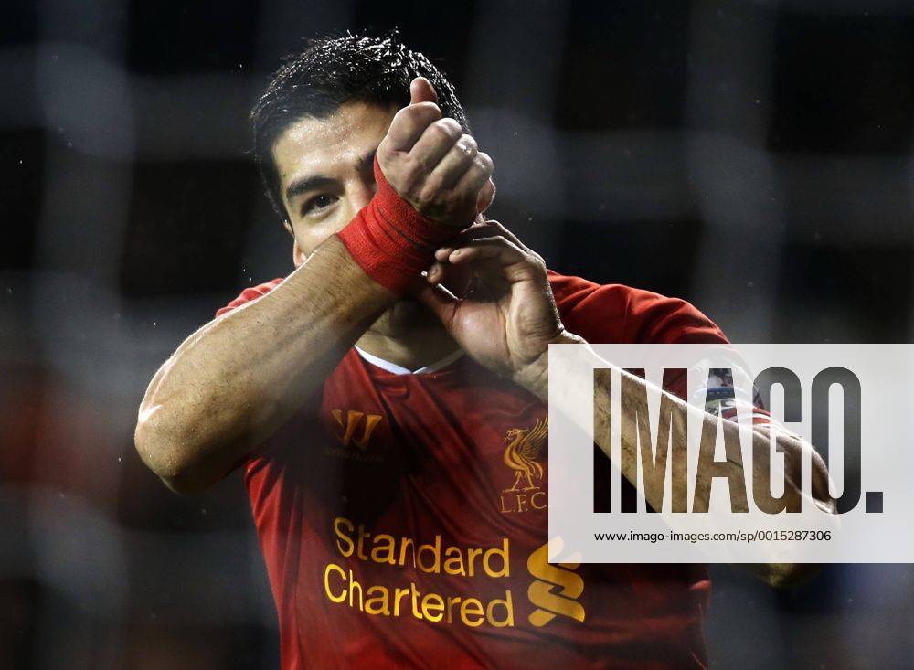 Luis Suarez of Liverpool celebrates scoring their fourth goal during the Barclays Premier League match between Tottenham Hotspur and Liverpool at White Hart Lane in London, Britain on Dec. 15, 2013. Liverpool won 5-0. (Xinhua Wang Lili) FOR . NOT FOR SALE FOR MARKETING OR ADVERTISING CAMPAIGNS. NO USE WITH UNAUTHORIZED AUDIO, VIDEO, DATA, FIXTURE LISTS, CLUB LEAGUE LOGOS OR LIVE SERVICES. ONLINE IN-MATCH USE LIMITED TO 45 IMAGES, NO VIDEO EMULATION. NO USE IN BETTING, GAMES OR SINGLE CLUB LEAGUE PLAYER PUBLICATIONS. (SP)BRITAIN-LONDON-SOCCER-PREMIER LEAGUE-TOTTENHAM HOTSPUR VS LIVERPOOL