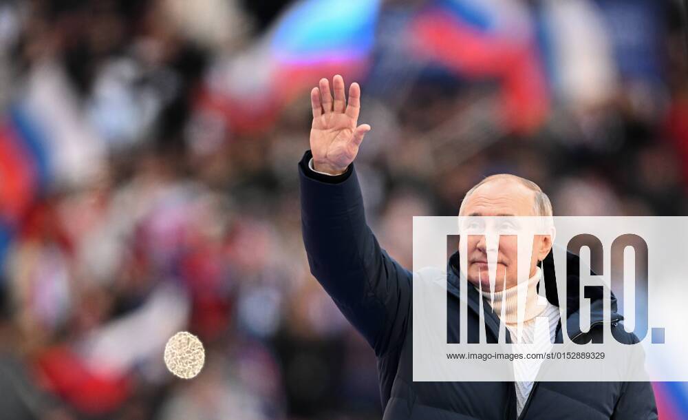KW11 Russia Crimea Reunification Anniversary 8143793 18.03.2022 Russian President Vladimir Putin waves during a concert marking the 8th anniversary of the referendum on the state status of Crimea and Sevastopol and its reunification with Russia, at Luzhniki Stadium in Moscow, Russia. Ramil Sitdikov Sputnik Moscow Russia