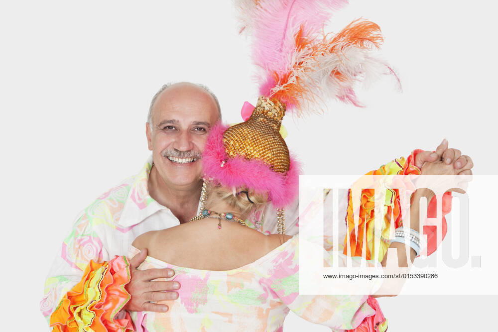 Portrait of senior couple in Brazilian outfits dancing over gray background, model released, , property released, , 10121408.jpg, 60-64 Years, 60s Adult, Adult, Back View, Balding, Brazilian Culture, Carnival, Caucasian Ethnicity, Celebration, Cheerfulness, Clothing, Colored Background, Copy Space, Couples, Cutout, Dancer, Dancing, Enjoyment, Female, Gray Background, Hair Ornament, Happiness, Head And Shoulders, Headdress, Headgear, Holding Hands, Looking At Camera, Male, Men, Multicolored, Outfit, People, Portrait, Senior Adult, Senior Man, Senior Woman, Smiling, Standing, Studio Shot, Tradition, Traditional Clothing, Traditional Culture, Traditional Style, Two, Two People, Women