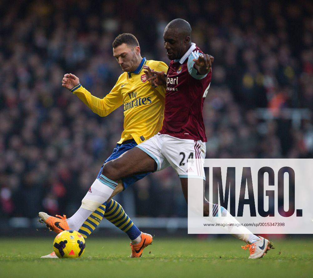 Arsenal s Thomas Vermaelen battles Carlton Cole of West Ham - West Ham vs. Arsenal - Barclays Premier League - Boleyn Ground - London - 26 12 2013 Pic Philip Oldham Sportimage .