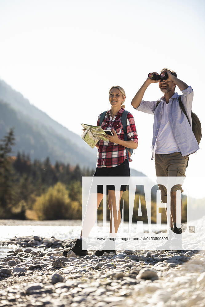Austria, Alps, couple on a hiking trip with map and binoculars model released, UUF16532