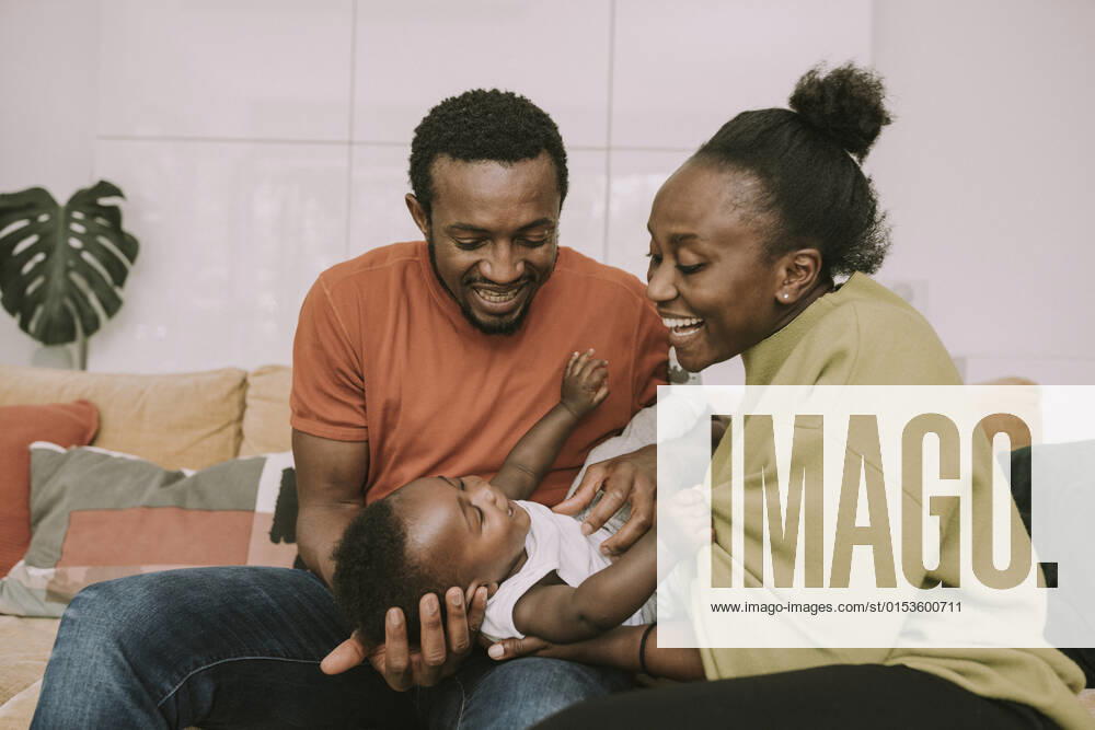 Happy parents tickling baby boy at home model released property released, MFF08458