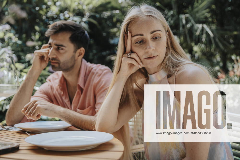 Couple ignoring each other at outdoor table model released property released, MFF08619