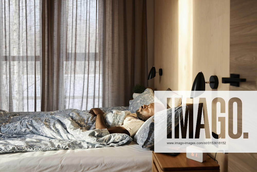 Man sleeping on cozy bed in morning at home model released property released, DSHF00135