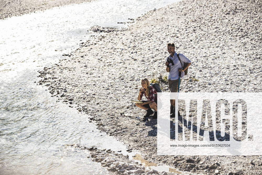 Austria, Alps, couple on a hiking trip having a break at a brook model released, UUF16599