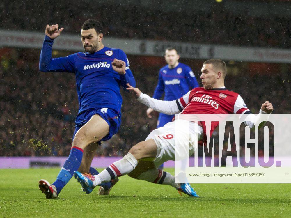 London, England. Lukas Podolski of Arsenal and Steven Caulker of Cardiff City during the Premier League game between Arsenal and Cardiff City from the Emirates Stadium. Arsenal won the game 2-0. Cookex ActionPlus20159925
