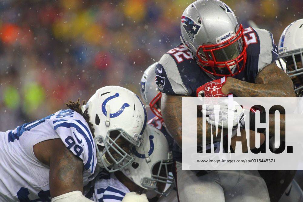 New England Patriots running back Stevan Ridley (22) charges into the end zone on a two-point conversion as Indianapolis Colts defensive end Ricky Jean Francois (99) tries to drag him down in the third quarter of the AFC Divisional Playoff game at Gillette Stadium in Foxboro, Massachusetts on January 11, 2014. The Patriots defeated the Colts 43-22. BOS2014011108