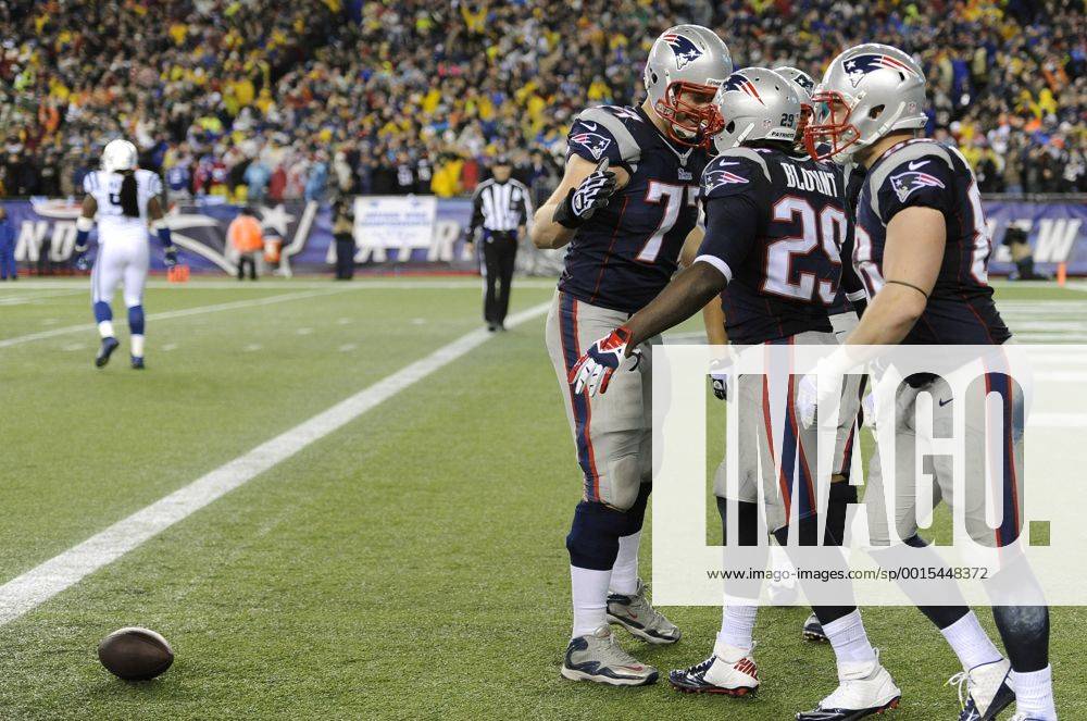 New England Patriots running back LeGarrette Blount (29) is congratulated by Patriots tackle Nate Solder (77) after Blount scored on a 73-yard touchdown in the fourth quarter against the Indianapolis Colts in the AFC Divisional Playoff game at Gillette Stadium in Foxboro, Massachusetts on January 11, 2014. The Patriots defeated the Colts 43-22. BOS2014011109