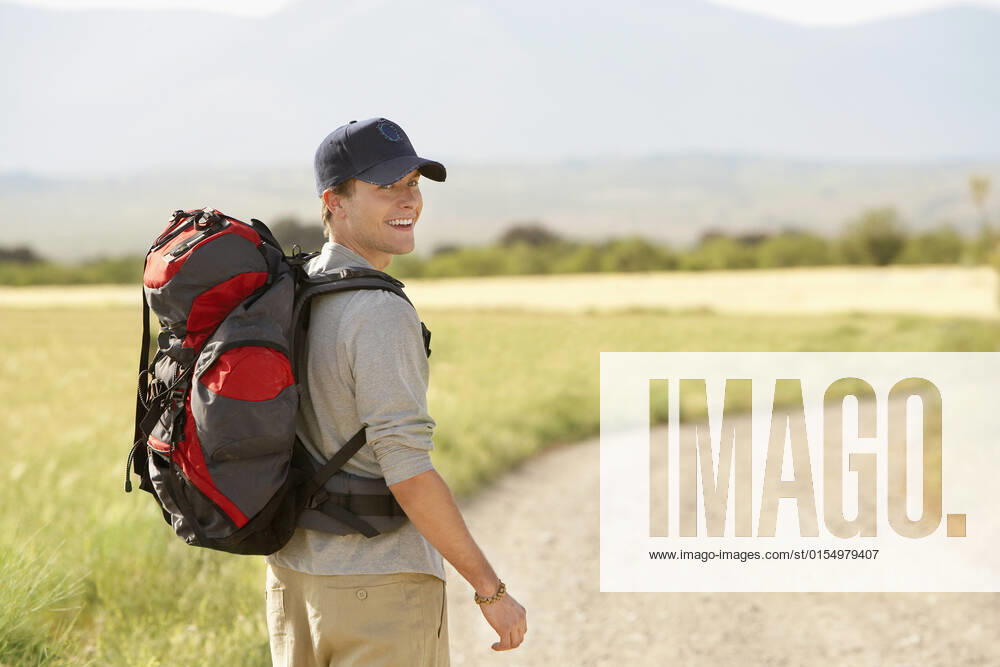 Man With Backpack Walking On Country Road, model released, , 9908034.jpg, 20s, Active, Activity, Adult, Adventure, Backpack, Backpacking, Cap, Casual, Caucasian, Copyspace, Country, Day, Enjoyment, Freedom, Granada, Grass, Happiness, Happy, Healthy, Hiker, Hiking, Horizontal, Landscape, Leisure, Lifestyle, Looking, Male, Man, Men, One, Outdoors, People, Person, Portrait, Recreation, Remote, Road, Shoulder, Smile, Smiling, Spain, Touring, Tourism, Tourist, Travel, Trekking, Vacation, Walking, Young,