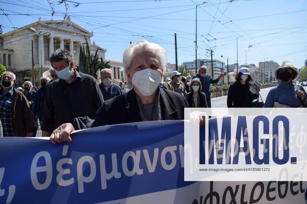 Greece: Thousands take to Athens streets in protest of price hikes Senior woman pensioner protests holding a banner with slogans against soaring unbearable prices that plague Greek society. Athens Greece