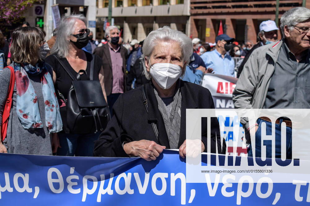 Greece: Thousands take to Athens streets in protest of price hikes Senior woman pensioner protests holding a banner with slogans against soaring unbearable prices that plague Greek society. Athens Greece