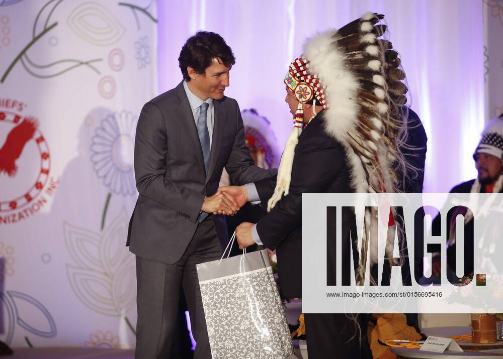 Prime Minister Justin Trudeau gives a gift to Southern Chiefs Organization Grand Chief Jerry Daniels at a HudsonöÄÃ s Bay Company transfer ceremony in Winnipeg Friday, April 22, 2022. One of the landmark stores formerly run by the HudsonöÄÃ s Bay Company is about to undergo a major transformation in the name of reconciliation with Indigenous people. WINNIPEG CANADA - ZUMAc35_ 20220422_zaf_c35_027