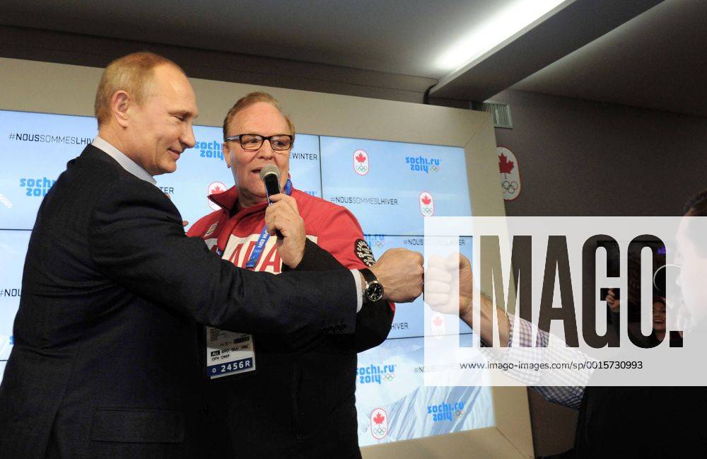 ITAR-TASS: SOCHI, RUSSIA. FEBRUARY 14, 2014. Russia s president Vladimir Putin (L) and Canadian Olympic Committee president Marcel Aubut at the Canada House in Olympic Park during the Sochi 2014 Winter Olympic Games. premiumd kurios Aufmacher RE139501