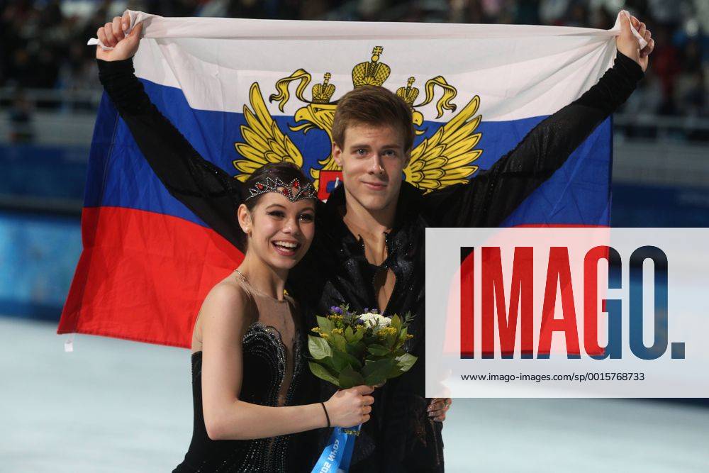 ITAR-TASS: SOCHI, RUSSIA. FEBRUARY 17, 2014. Bronze medalists Elena Ilinykh and Nikita Katsalapov of Russia pose with their national flag at a flower ceremony for the figure skating ice dancing competition at the Iceberg Skating Palace during the Sochi 2014 Winter Olympics. premiumd Highlight RE139D69