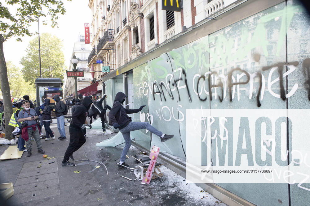 The Black Bloc anarchists ransack a McDonald s restaurant on the Place Leon Blum during the demonstration. Thousands of demonstrators joined the May Day March in Paris on 1st May, International workers day. The March started from La Republique Square towards Nation Square. Paris France - ZUMAs197 20220501_zaa_s197_331
