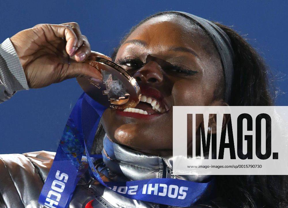 Feb. 20, 2014 - Sochi, Krasnodar Krai, Russia - USA s Women s Bobsleigher Aja EVANS(Bronze medal) takes a bite of BRONZE during the Winter Olympics on February 20 in Sochi, Russia. Cross-Country Skiing Men s Team Sprint Classic - Sochi 2014 Cross-Country Skiing Ladies Team Sprint Classic - Sochi 2014 Men s Alpine Skiing - Sochi 2014 Women s Bobsleigh - Sochi 2014 - ZUMAa35