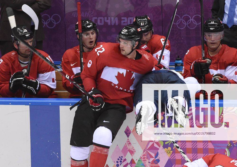 Canada s Jamie Benn (22) checks USA s Phil Kessel into the Canada bench during the play-offs semifinals at the Sochi 2014 Winter Olympics on February 21, 2014 in Sochi, Russia. Canada defeated USA 1-0 to advance to the gold medal game against Sweden. USA will play Finland for the bronze. OLY20140221714