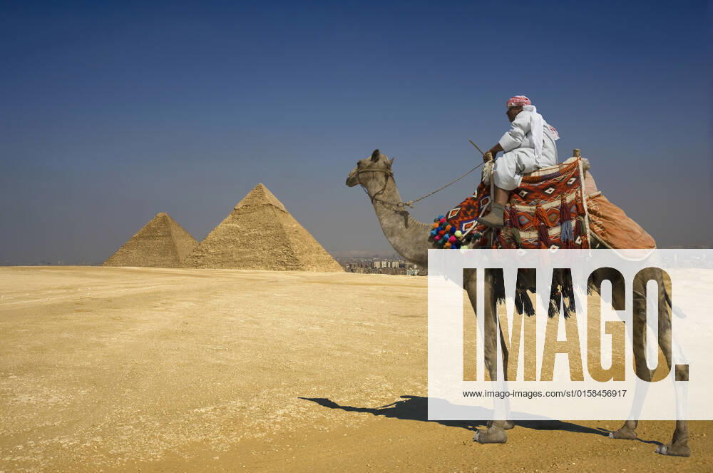 The Great Pyramids, model released, , 10114932.jpg, Outdoors,Full Length,Standing,Sitting,Transportation,Architecture,Pyramid,Desert,Mystery,Historic,International Landmark,Tranquil Scene,Camel,Egypt,domestic animals,the past,ancient civilization,1 Person,1 Animal,Old Ruin,Cairo,Egyptian Culture,The Great Pyramids,Giza Pyramids, Cairo, Egypt