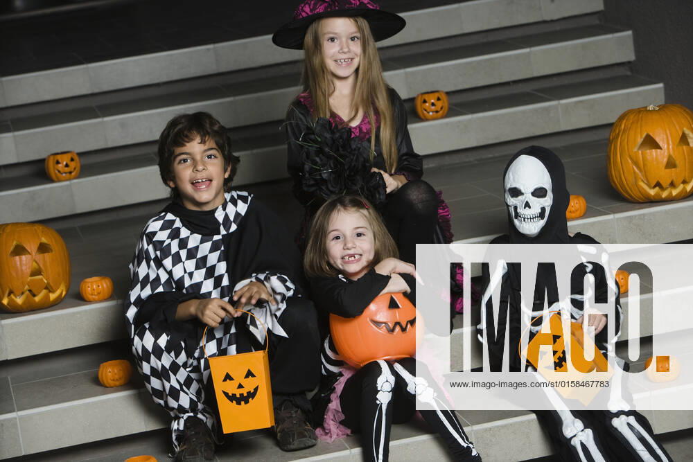 Portrait of boys and girls (7-9) wearing Halloween costumes on steps, model released, , property released, , 10107382.jpg, Outdoors,Full Length,Fun,Whites,Portrait,Eye Contact,Smiling,people,Sitting,7-9 Years,Childhood,Friendship,Pre-Teen Boy,Group Portrait,Few,Tradition,Pre-Teen Girl,Celebration,Obscured Face,Night,Party,Costume,Bag,White Background,Stairs,Dressing Up,Steps,Fantasy,Haunting,Skeleton,Halloween,Trick Or Treat,Pumpkin,jack o lantern,jack-o-lantern,scary,frightening,Halloween costume,witch,Fancy Dress Costume,Witch Hat,Dressing Up costume,Jester,Skeleton Costume, California
