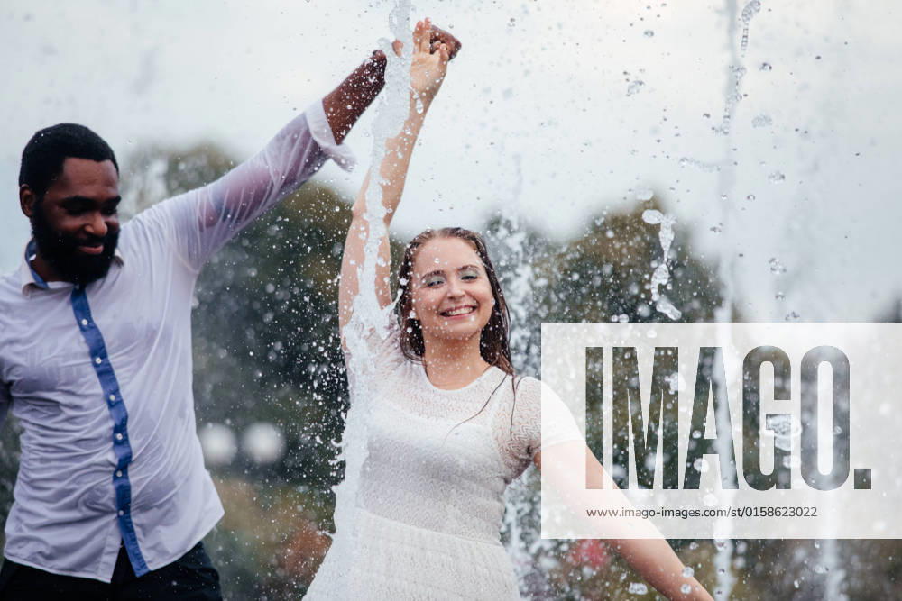 IMAGO Creative: Sommer, Sommertage im Stadtpark The couple of diverse people are dancing in a city fountain Uzhhorod, Zakarpattia Oblast, Ukraine CR_OKSH211029-855852-01 ,model released, Symbolfoto