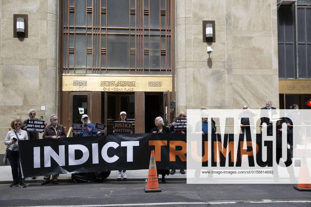 Members of activist organization Rise And Resist protested outside of Manhattan District Attorney Alvin Braggâ€⠢s office calling for indictments for the Jan 6 coup leaders. Protesters held a large banner that reads â€oeIndict Trumpâ New York USA - ZUMAr174 20220511_znp_r174_046