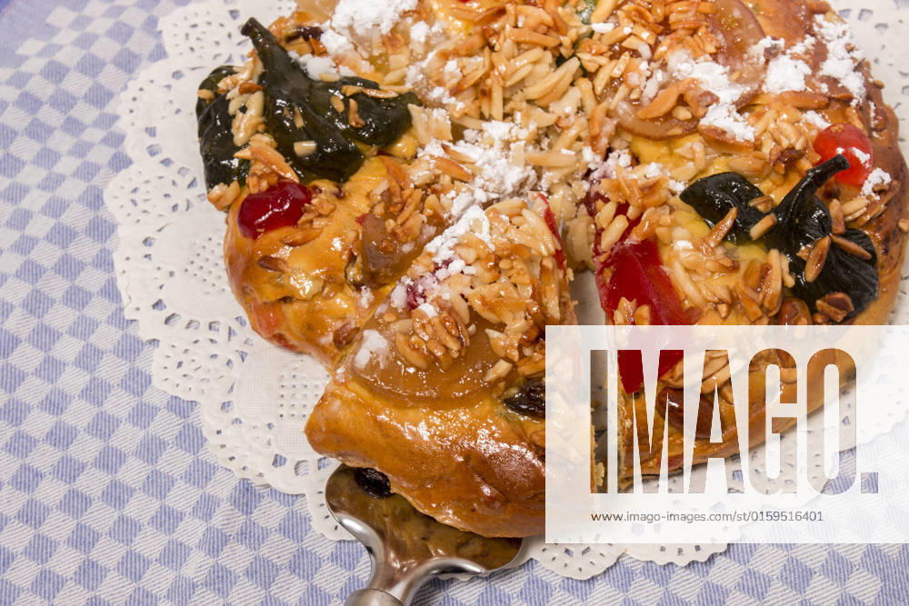 Portuguese King Cake is a famous christmas celebration cake with dry nuts and crystalized fruits. , 25769748.jpg, almond, background, baked, bakery, cake, christmas, colorful, crystallized, cuisine, dry, fig, fluffy, food, fruit, gastronomy, glace, grape, icing, isolated, king, nut, pastry, pine, pinea, pinus, portugal, portuguese, raisin, round, seasonal, seed, sugar, sweet, tasty, top, tradition, traditional, typical, view, white, xmas, cloth, table,