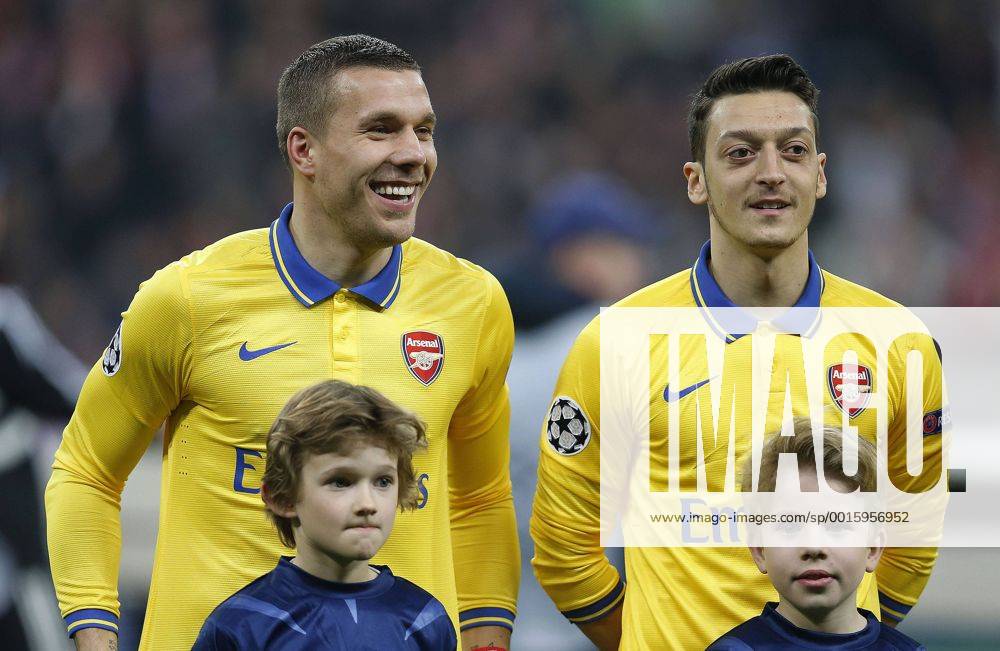 München, Deutschland, Germany, Fussball, Football, Soccer, UEFA Champions League , Achtelfinale FC Bayern München : Arsenal FC 1-1 in München Germany am 11. 03. 2014, Lukas PODOLSKI (ARS) -li.- und Mesut ÖZIL (ARS) re.-