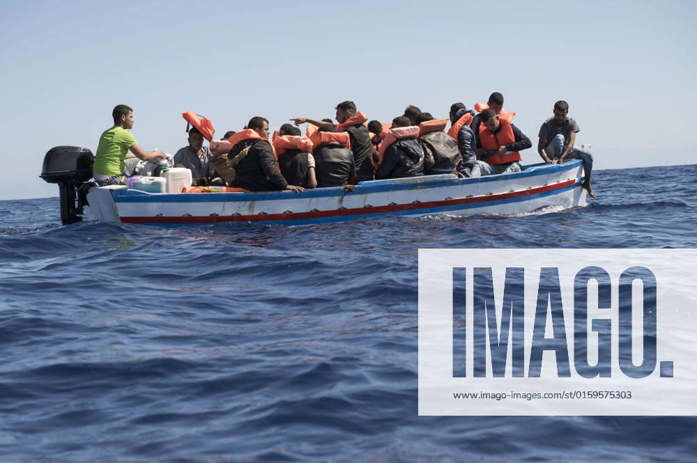 Migrants seen on a wooden boat under the sun. During the 91st mission, 23 person, from Tunisia, were rescued by the crew of Astral, the sailing vessel of the Spanish NGO Open Arms, in Maltaâ€⠢s SAR Zone. Catanzaro Malta - ZUMAf172 20220521_zip_f172_031