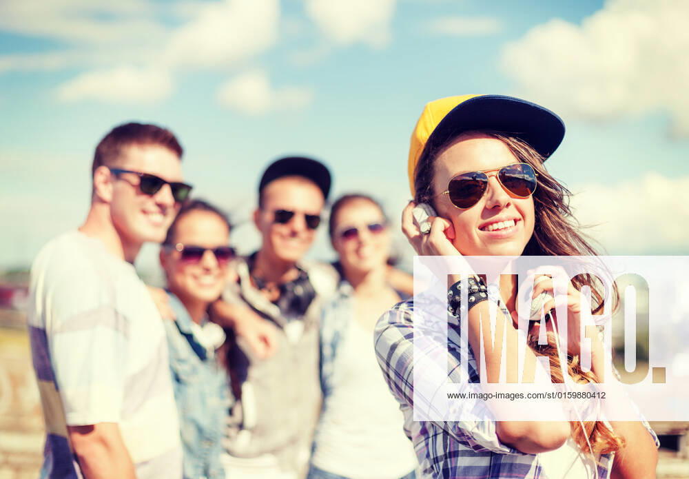 Summer holidays and teenage concept - teenage girl in sunglasses, cap and headphones hanging out with friends outside, model released, , 18785254.jpg, summer, girl, holidays, group, teenagers, urban, culture, friends, street, style, lifestyle, girls, hip, hop, modern, school, city, youth, young, women, men, boys, beautiful, happy, smiling, people, outdoors, standing, music, fun, fashion, funky, students, together, hanging, out, vacation, friendship, laughing, chilling, sunglasses, shades, love, teens, cap, headphones, having, listening, podcast, radio,