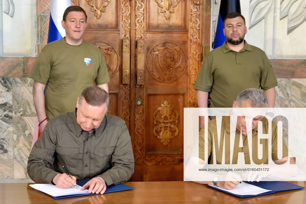 St Petersburg Governor Alexander Beglov and Mariupol Mayor Konstantin Ivashchenko (L-R seated) sign a twinning agreement between St Petersburg and Mariupol as United Russia Party General Council Secretary Andrei Turchak and Donetsk People s Republic leader Denis Pushilin (L-R standing) look on. Nikolai Trishin TASS TS1339BB