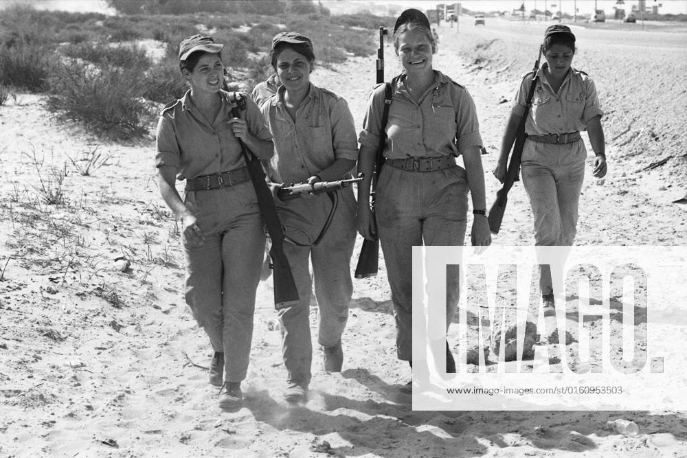 Israeli female soldiers marching with their rifles, during basic training, marching, during the Yom Kippur War, the Yom Kippur War between Israel and the Arab states of Egypt, Jordan and Syria lasted from October 6 to October 25, 1973,